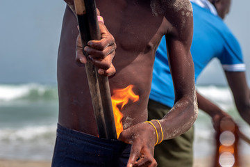 Boy with fire in his pants. A performance on a beach in Accra Ghana. One way to get extra money.