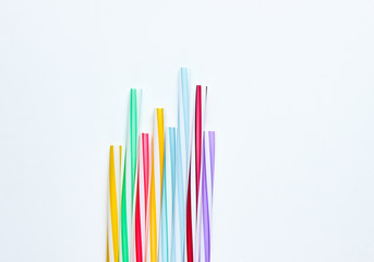 Lot of multi-colored cocktail tubes on white background. Top view