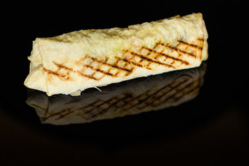 Shawarma with chicken and cabbage on a dark background.