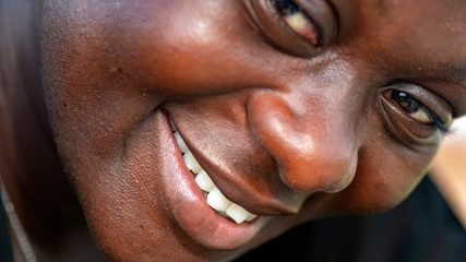 Happy African woman looking towards camera.