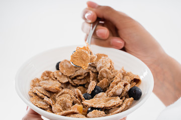 Portrait of plate with cornflakes and blueberry