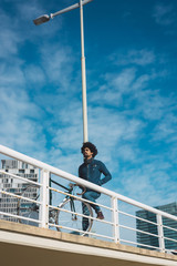 Man with afro hair riding a vintage style bicycle