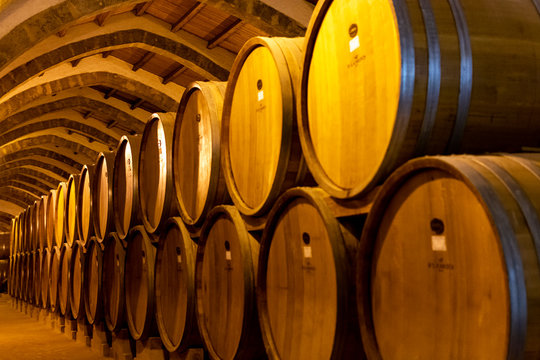 Vintage wine cellar with old oak barrels, production of fortified dry or sweet marsala wine in Marsala, Sicily, Italy