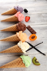 ice cream scoops of different colors and flavours with berries, nuts and fruits decoration on white background
