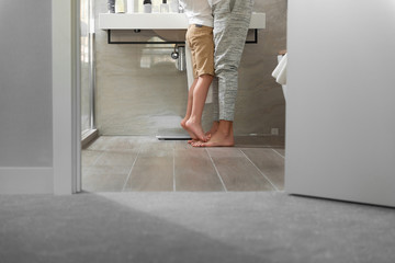 Adult father and son are staying in the bathroom at home