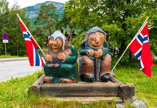 Wooden sculptures with Norwegian flags in the entrance of Sjoa village. Oppland, Norway