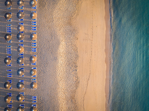 Aerial view of coastline beach , deck chairs and umbrellas in Al Aqah, Dubai.