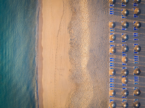 Aerial view of coastline beach , deck chairs and umbrellas in Al Aqah, Dubai.