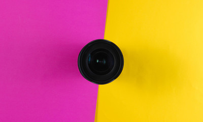 Lens on a colored paper background.