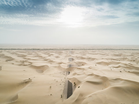 Aerial abstract view of road covered by sand in the desert, Abu Dhabi, UAE.
