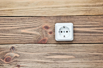 Power socket on wooden wall, minimalism