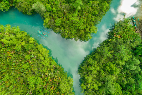 Aerial view of traditional fishing boats in Bojo River, Aloguinsan, Philippines.