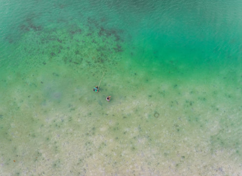 Aerial view of two men fishing near Borja Bridge, Dauis, Philippines.