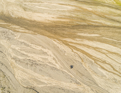 Aerial abstract view of one car in desert like landscape in Tarlac, Philippines.