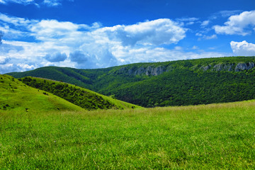 Fototapeta na wymiar Beautiful landscape with meadows and hills near to Torocko in Transylvania, Romania