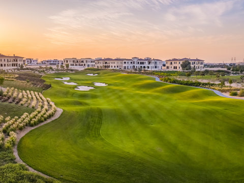 Aerial view of green golf club on a luxury residential area, Dubai, U.A.E.