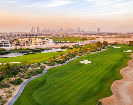 Aerial view of luxury golf club with Dubai at the background, U.A.E.