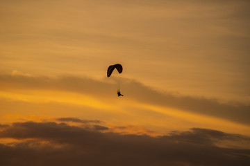 The silhouette of the paramotor at sunset