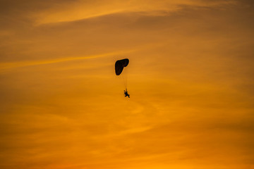 The silhouette of the paramotor at sunset