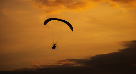 The silhouette of the paramotor at sunset