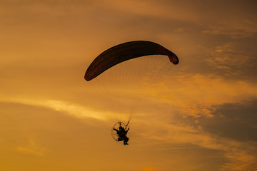 The silhouette of the paramotor at sunset