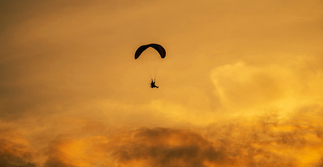The silhouette of the paramotor at sunset