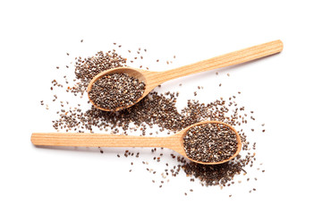 Chia in wooden spoons isolated on white background.