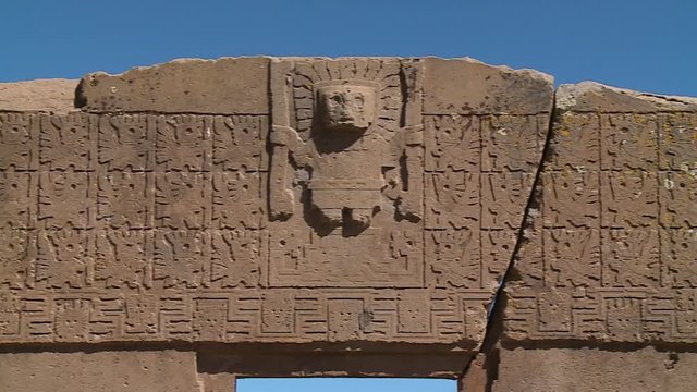 Close-up low angle panning shot of the detailed stone carvings on the Gate of the Sun, La Paz, Bolivia