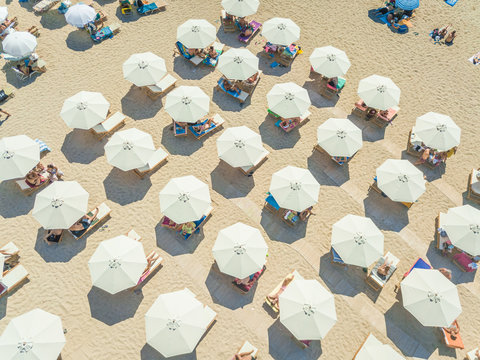 Aerial view of beach with white parasols on Achaia, Greece.