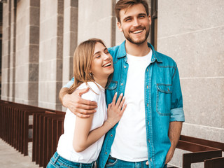 Portrait of smiling beautiful girl and her handsome boyfriend. Woman in casual summer jeans clothes. Happy cheerful family. Female having fun on the street background