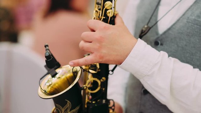 Close up of male's hands playing the saxophone
