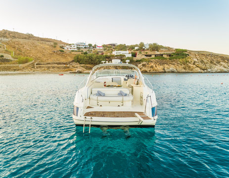 Close aerial view of luxurious yacht with catering, Mikonos island, Greece.