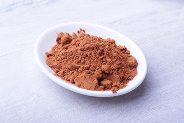 cocoa powder. ingredient for homemade tiramisu cake in close up.