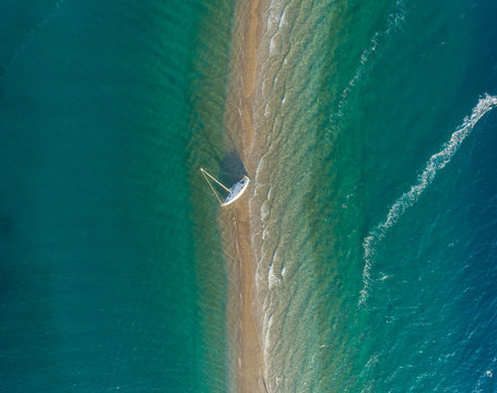 Aerial view of trail of person practicing windsurfing in the Gulf of Patras, Greece.