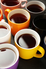 Black tea (coffee) in bright cups, office break, team building.