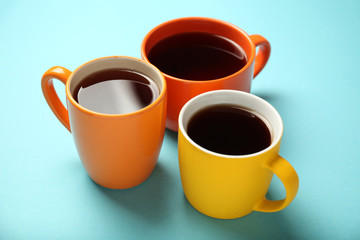 Black tea (coffee) in bright cups, office break, team building.