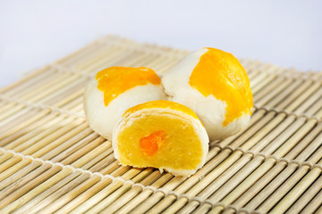 Chinese pastries or moon cake with mung bean and yolk inside on bamboo mat. Tradition food of china