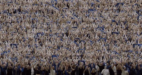 MODEL RELEASED Front view sports crowd fans wearing blue clothes celebrating during a sport event. 4K UHD ProRes 422 HQ