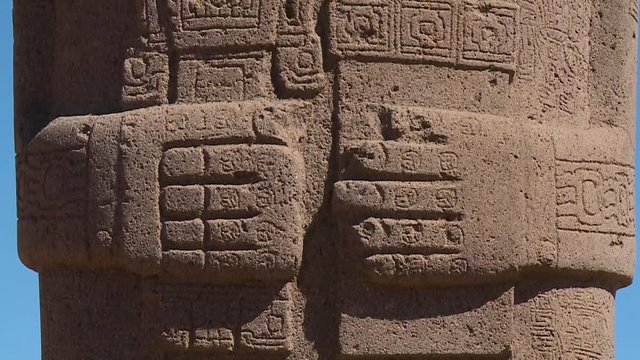 Extreme close-up low angle tilting shot of Ponce Monolithic statue's hand and body stone carvings, La Paz, Bolivia