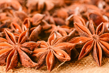 Star anise. Some star anise fruits with seeds 7. Macro close up on the jute burlap canvas.