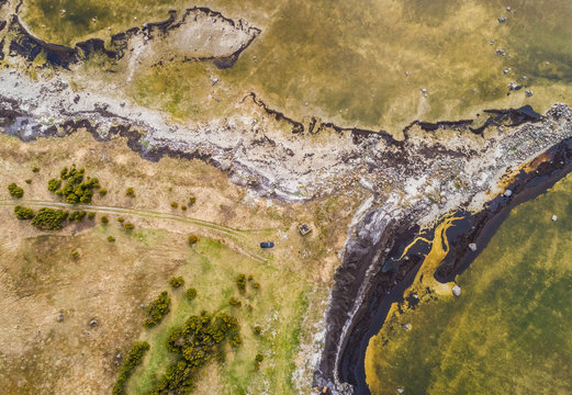 Aerial view of abstract patterns in nature made by algae bloom on coastline in Estonia
