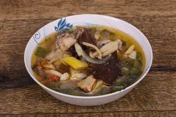 Thai style soup with meat and mushrooms