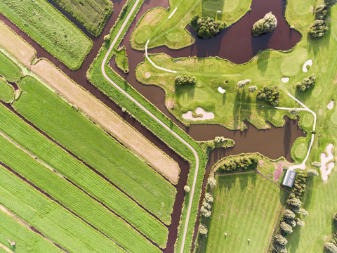 Aerial photography of green meadows and golf course in Krimpen aan de Lek.