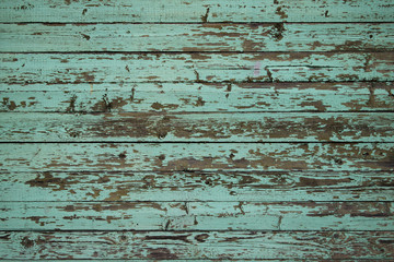 Fototapeta na wymiar Green colored wall made of wooden planks.