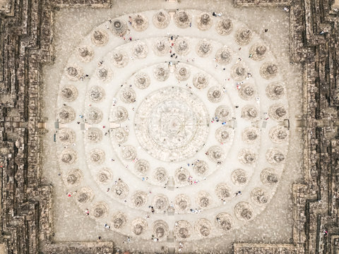 Aerial view of people walking on the top of Borobudur world's largest buddhist temple in Java, Indonesia.