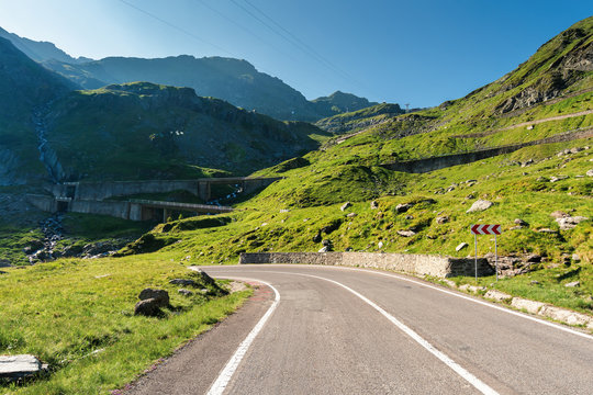 transfagarasan the most beautiful road in romania. amazing transportation scenery on summer morning. clear blue sky and some haze on the distant mountain tops