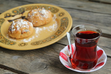 cup of tea on the table and cake