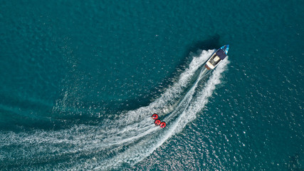 Aerial photo of extreme powerboat donut watersports crusing in high speed in tropical turquoise bay