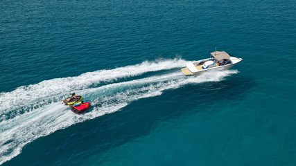 Naklejka premium Aerial photo of extreme powerboat donut watersports crusing in high speed in tropical turquoise bay
