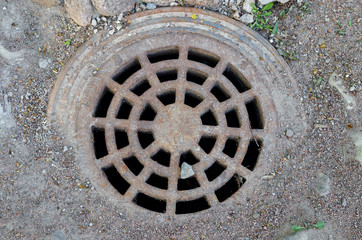 The metal vintage rusty manhole